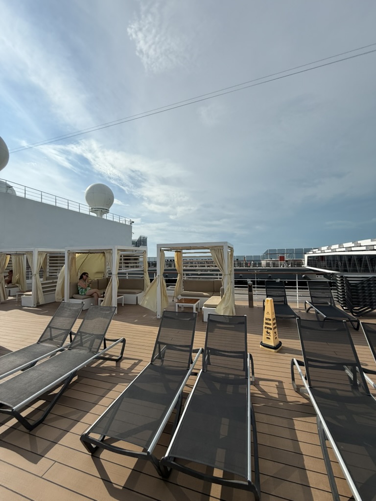 Sun loungers and shaded cabanas on an open MSC sun deck under a bright sky.